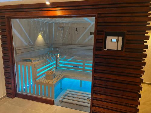 an inside view of a sauna with blue water at Alm'a Residence in Kitzbühel