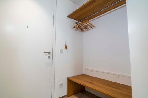 a room with a wooden bench next to a door at Zweite Heimat in Lochau