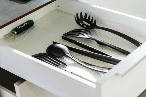 a drawer with utensils in a white drawer at Zweite Heimat in Lochau