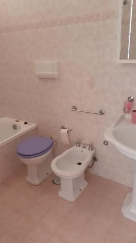 a bathroom with a toilet and a bidet and a sink at Residence Anna in Paestum