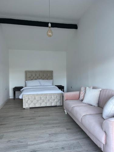 a bedroom with a bed and a couch at Cosy apartment with fire stove in Athlone