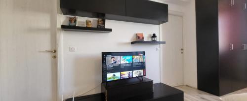 a living room with a flat screen tv on a wall at Studio 23 Constantin Brancoveanu, Craiovita, Self check-in in Craiova