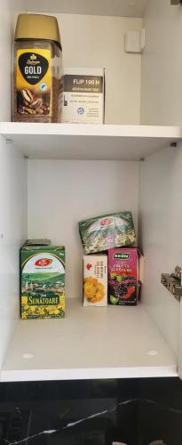 a shelf with some food items on it at Studio 23 Constantin Brancoveanu, Craiovita, Self check-in in Craiova