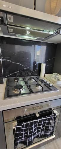 a stove top oven sitting in a kitchen at Studio 23 Constantin Brancoveanu, Craiovita, Self check-in in Craiova