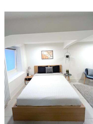 a bedroom with a large bed and a window at The Hidden Studio; Comfy & close to the Lake in Lugano