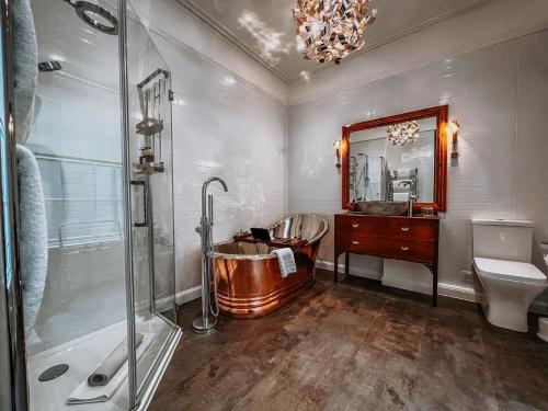 a bathroom with a copper tub and a sink at Atholl Arms Hotel Dunkeld in Dunkeld
