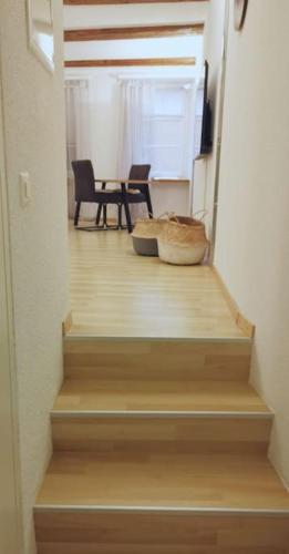 a staircase with two chairs and a table in a room at La Suite in Chur