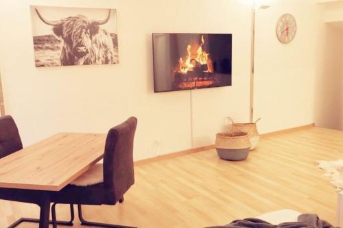 a living room with a table and a fireplace at La Suite in Chur