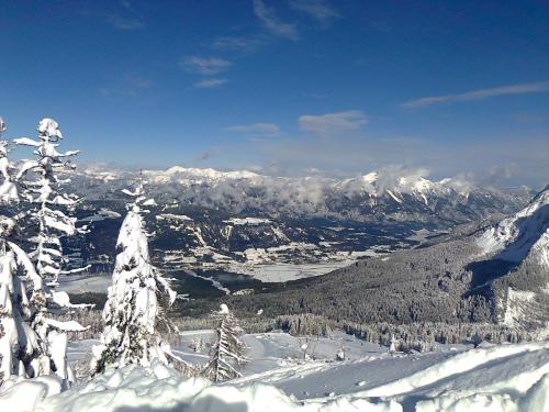 a snow covered mountain with a view of a valley at Ferienwohnungen Forellenhof Waldner in Gundersheim