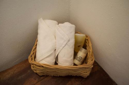 a basket filled with towels and candles on a wall at Aldea San Lam - Oasis Of Tulum in Tulum