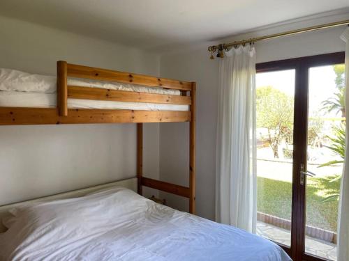 a bedroom with a bed and a large window at Charming Villa Saint-Jean-Cap-Ferrat in Saint-Jean-Cap-Ferrat