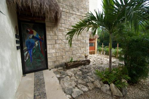 a door to a house with a painting on it at Aldea San Lam - Oasis Of Tulum in Tulum