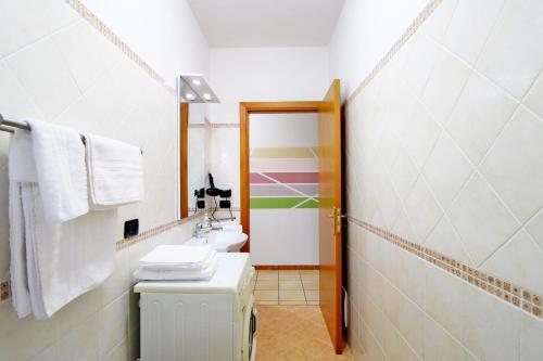 a small bathroom with a sink and a toilet at Capo d'Orlando Apartments - Cipria in Capo dʼOrlando