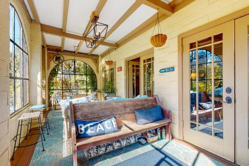 a porch with a couch on a house at Gatsby in Monte Rio
