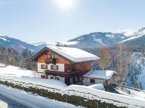 a house in the snow in the mountains at Haus Leitner in Westendorf