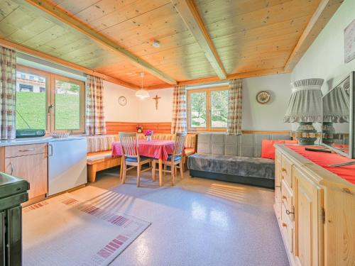 a kitchen and living room with a table and a couch at Haus Leitner in Westendorf