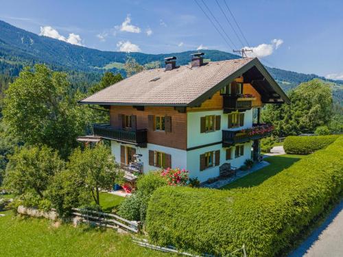 a house on a hill with bushes and trees at Haus Leitner in Westendorf