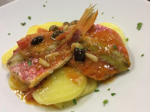 two pieces of food on a white plate withruit at Hotel Ariston & Apartments in Varazze