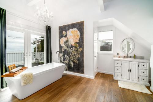 a bathroom with a large white tub and a painting on the wall at Agate Cove Inn in Mendocino