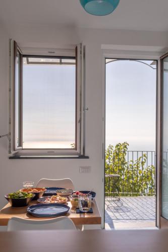 a kitchen with a table with food and a window at Lena Magda B&B in Furore