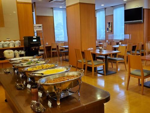 a buffet of food on a table in a restaurant at Hotel Route-Inn Kameyama Inter in Kameyama