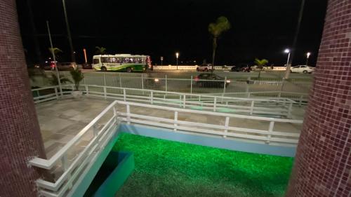 a building with a pool of green water at night at Apartamento encantador em prédio histórico in Santos