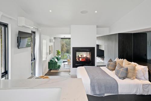 a bedroom with a large bed and a fireplace at Hepburn Bathhouse & Spa Villas in Hepburn Springs
