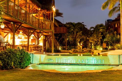 a resort with a swimming pool in front of a building at Hurricane Jeri in Jericoacoara