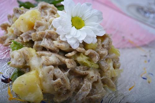 a white flower on top of a pile of food at Hotel Valtellina in Livigno