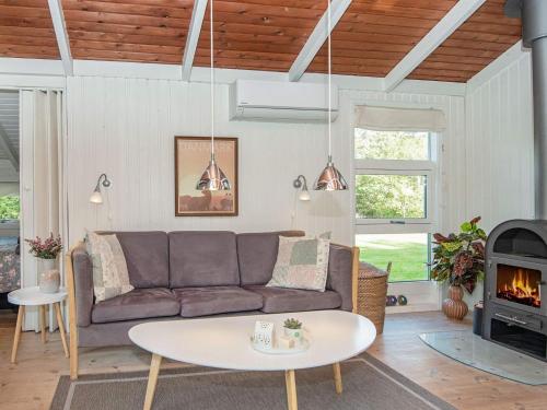a living room with a couch and a table at 4 person holiday home in Oksbøl-By Traum in Oksbøl