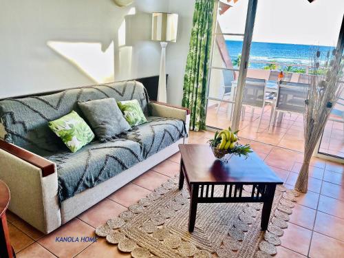 a living room with a couch and a table at KANOLA Home in Sainte-Anne