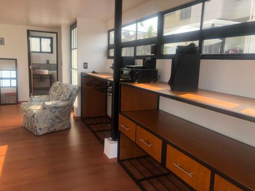 a office with a desk with a chair and a computer at Las Terrazas. in Mexico City