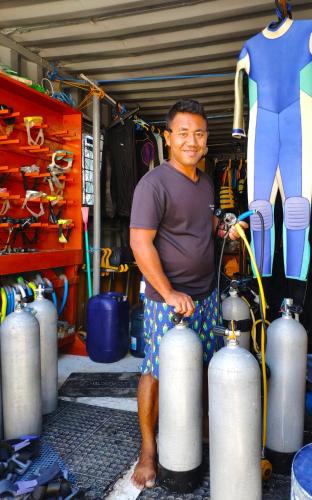 a man is standing in a room with cylinders at Anema Wellness & Resort Gili Lombok - Diving Center PADI in Tanjung
