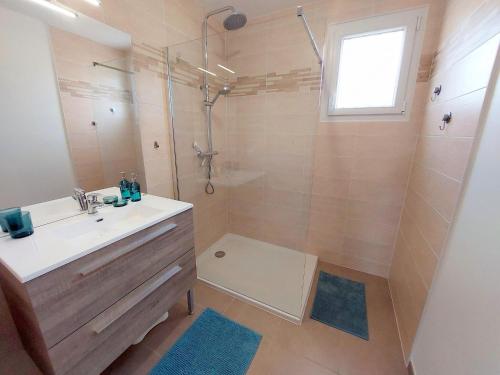 a bathroom with a sink and a shower at Single storey holiday home in Plouarzel in Plouarzel