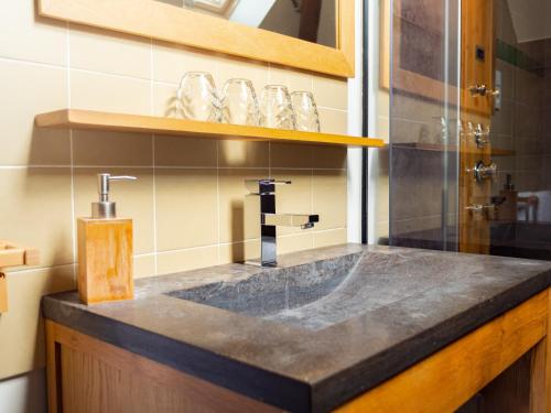 a bathroom with a sink and a glass shower at Le Relais des Lacs Bourgogne Morvan in Planchez