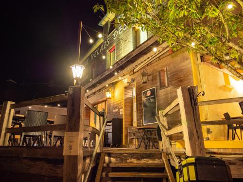 a wooden building with a deck at night at Le Relais des Lacs Bourgogne Morvan in Planchez