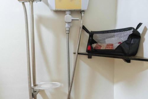 a shelf on a wall with a basket on it at RedDoorz at EM Pensiontel Butuan City in Butuan