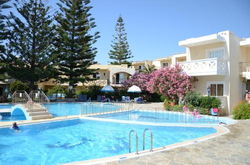 a large swimming pool in front of a building at Kastalia Village ,Saint Nikolas resort in Kolymvari