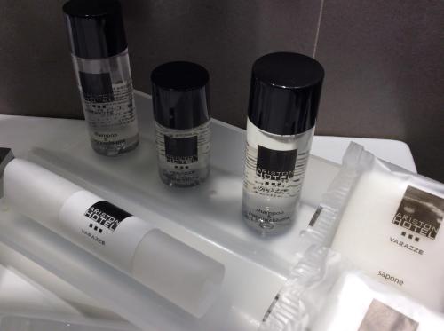 three bottles of hair products sitting on a shelf at Hotel Ariston & Apartments in Varazze