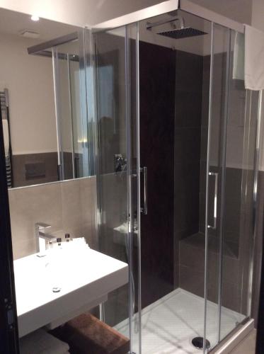 a bathroom with a shower and a sink at Hotel Ariston & Apartments in Varazze