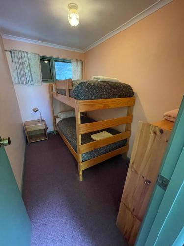 a small room with two bunk beds in it at Kosciuszko Base Camp in Khancoban