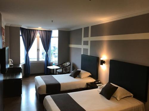 Кровать или кровати в номере Legend Inn Taiping