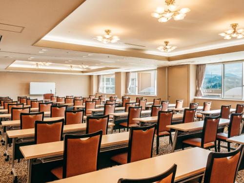 a classroom with tables and chairs in a room at KAMENOI HOTEL Kii-Tanabe in Tanabe