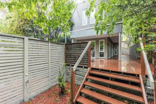a house with a fence and stairs in front of it at Spacious Villa Holiday Staycation in Canterbury East of Melbourne in Balwyn