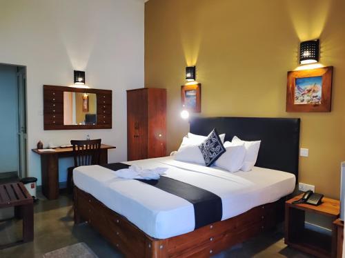 a bedroom with a large bed in a room at Nil Diya Beach Resort in Matara