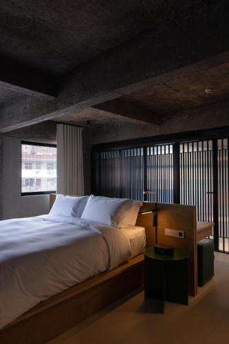 a bedroom with a large bed with white pillows at Jiangnan House Nantou in Shenzhen