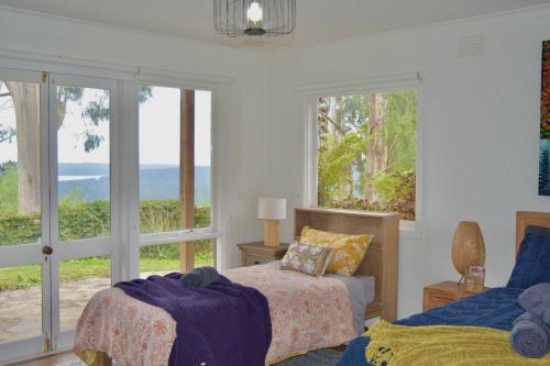 a bedroom with two beds and a view of the ocean at Villa Panorama in Kalorama