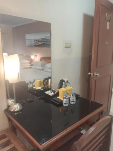 a desk in a room with a mirror at Hotel Celebes in Manado
