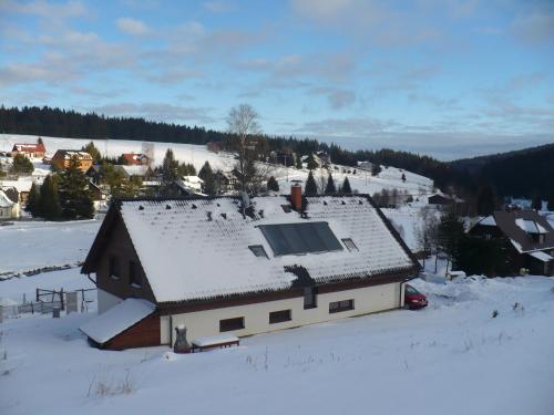 a house with a roof covered in snow at Wellness Chata Kastanek in Kvilda