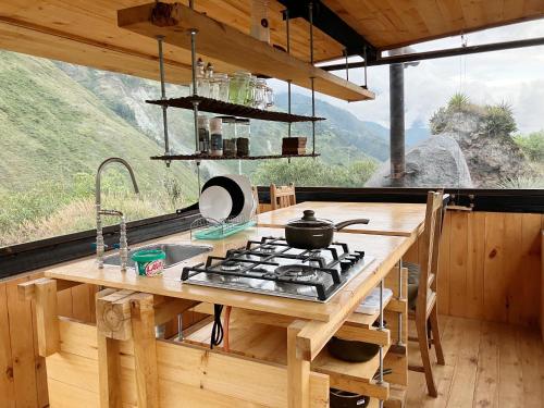a kitchen with a stove and a view of a mountain at Stunning cabin in Baños in Baños